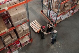 men working in wholesale warehouse