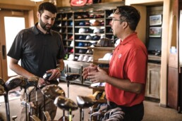 a customer and employee talking inside a sports retail store