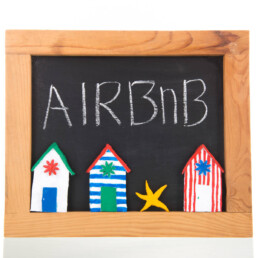AirBnB written in chalk with houses underneath